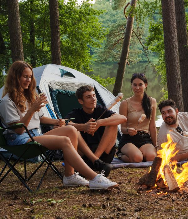 Group of friends sitting around a campfire.