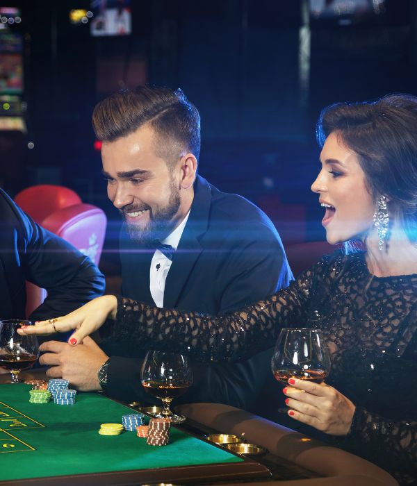 People playing at a casino table.